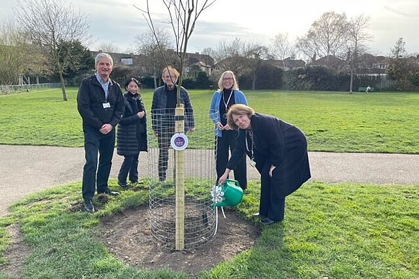 Group of local Lib Dems next to a newly printed tree